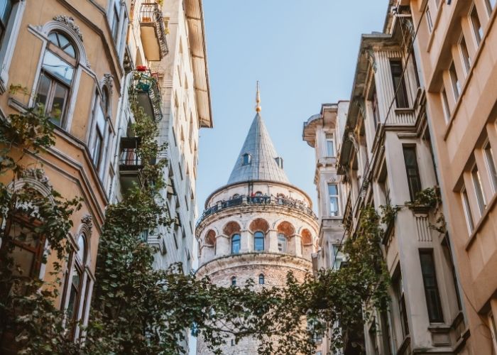 Galata Tower seen from an ivy-covered lane in the old Genoese quarter