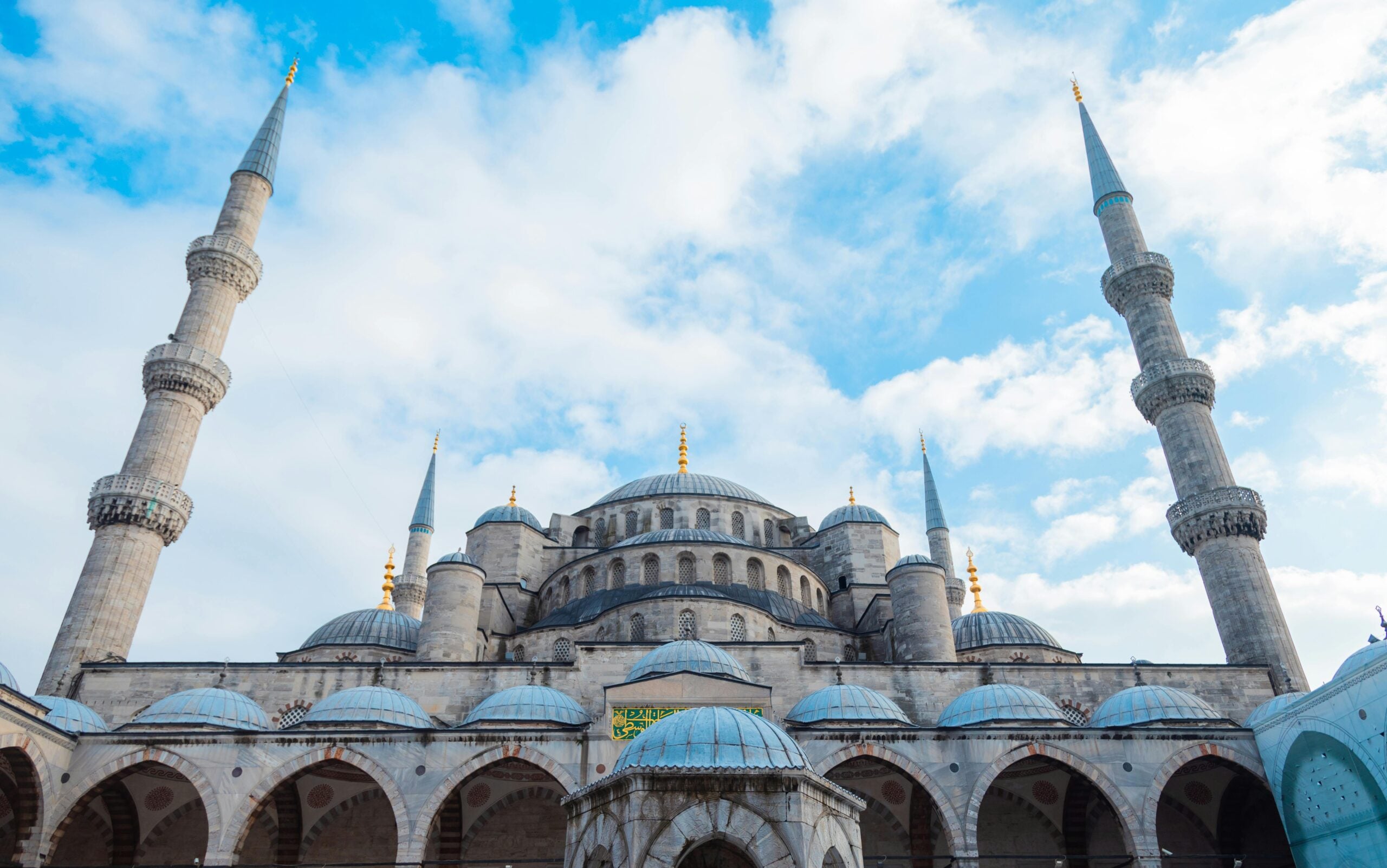The Blue Mosque courtyard with its cascading domes and minarets on a clear day