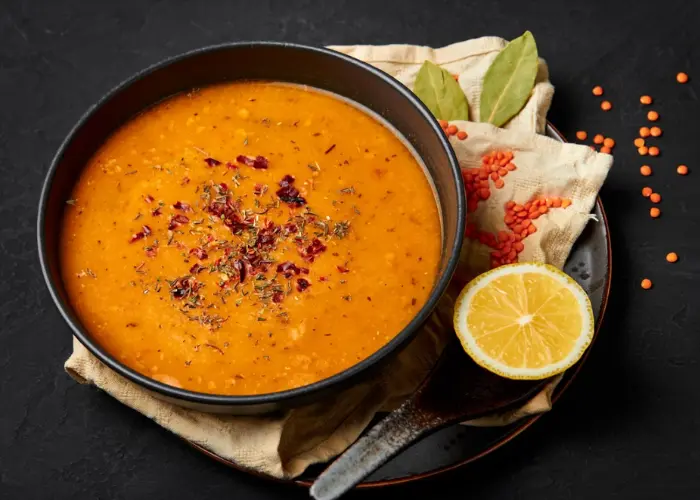 A bowl of ezogelin soup with mint garnish