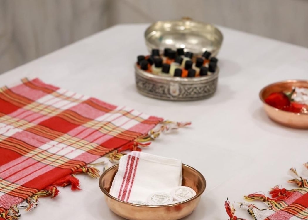 Peştemal wraps, copper bowl and hamam kit laid out for a session
